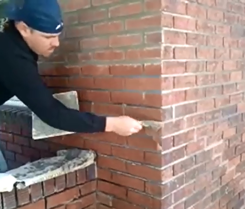 Tuckpointing Process in action. Mortar is being applied to open clean joints with hand made tools for the trade.